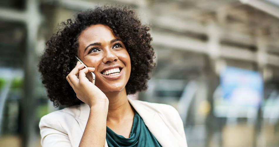 woman talking on phone while smiling